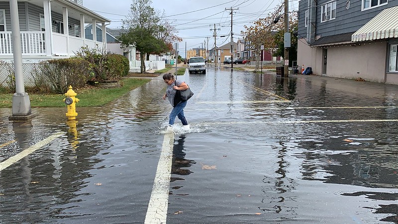 Supporters of the NJ Organizing Project trudged through flood waters Tuesday to show solidarity with homeowners who are still not back in their homes seven years after Superstorm Sandy.