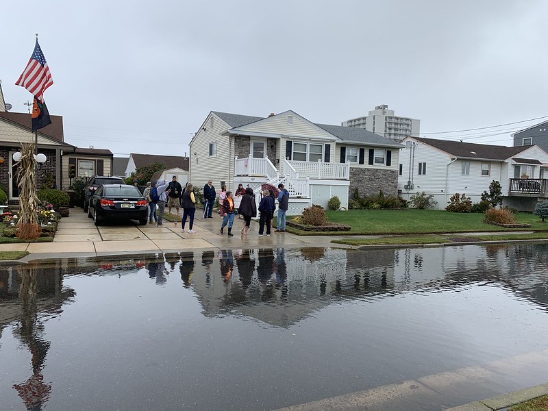 New Jersey Organizing Project members stand on a flooded street 
