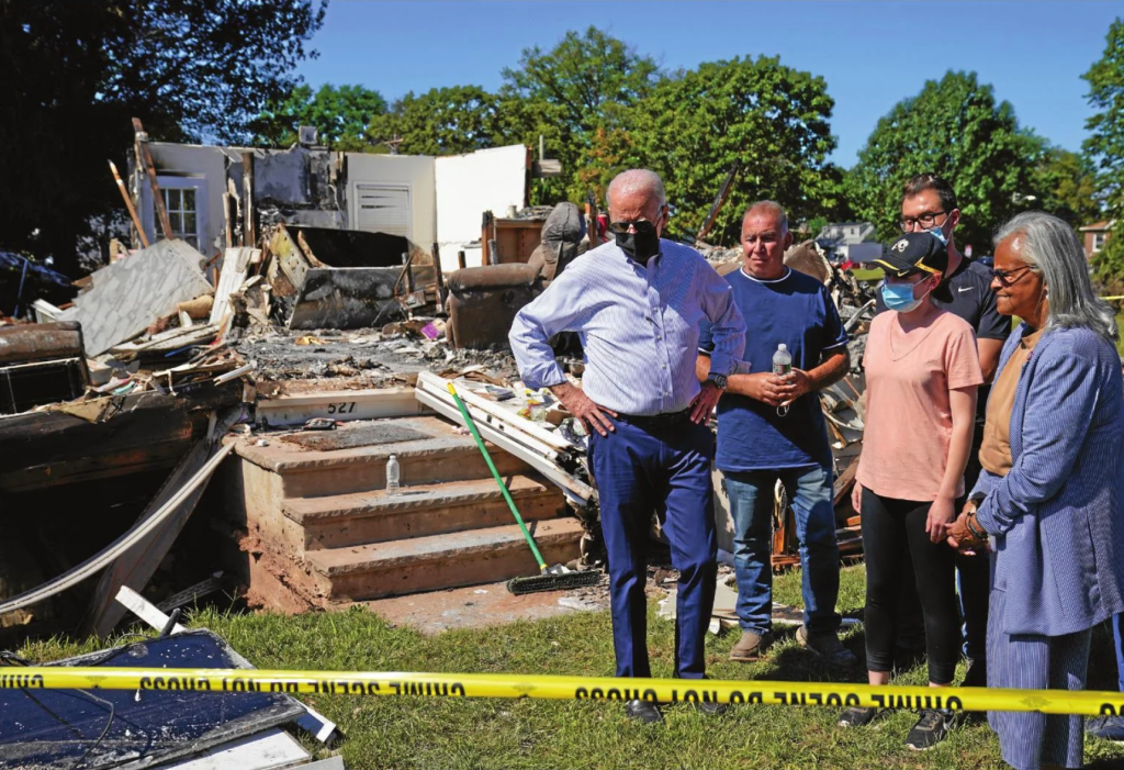 President Joe Biden tours a neighborhood impacted by Hurricane Ida on Sept. 7, 2021, in Manville, Somerset County. U.S. Rep. Bonnie Watson Coleman, D-N.J., looks on at right.