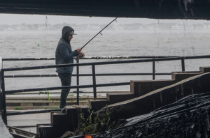 A person fishing off of the Mantoloking Bridge during a rainstorm caused by Hurricane Ian in Brick, NJ on Oct. 2, 2022